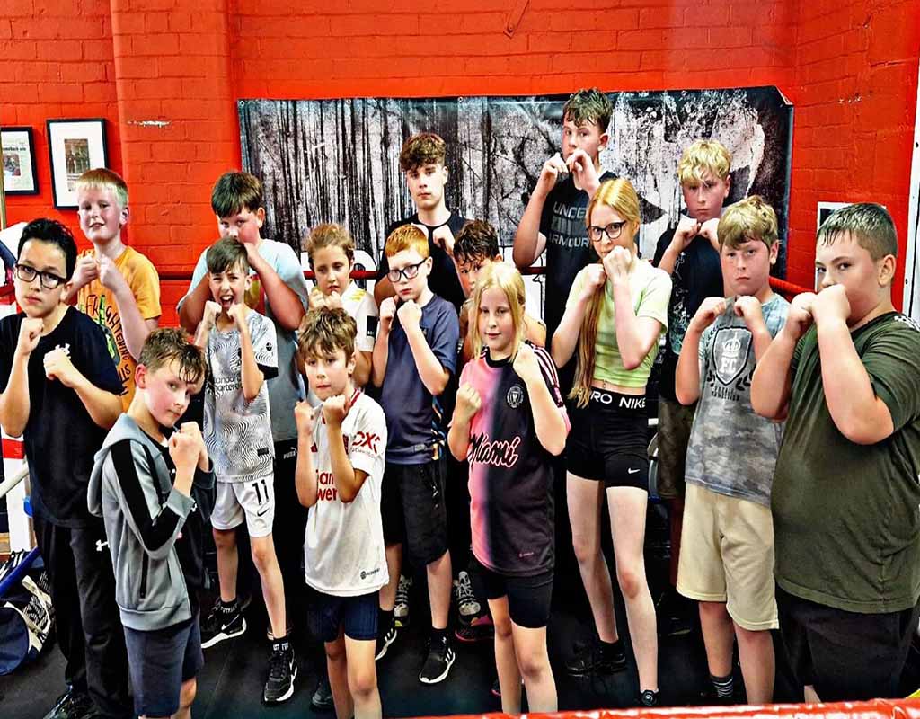 Children participating in youth boxing training session
