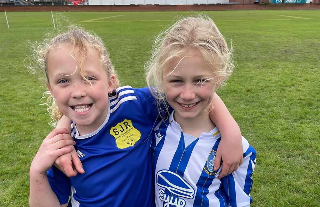 Two young athletes smiling during sports session