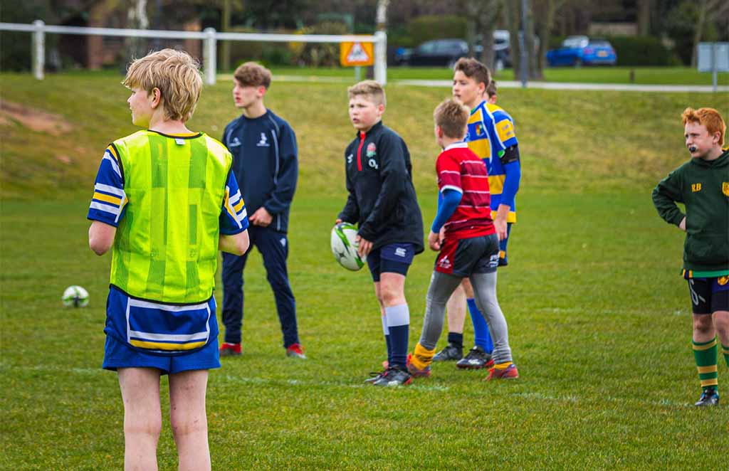 Young football players standing together during training session