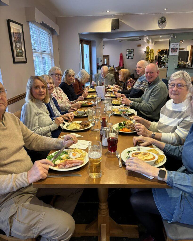 Community group sharing meal at restaurant