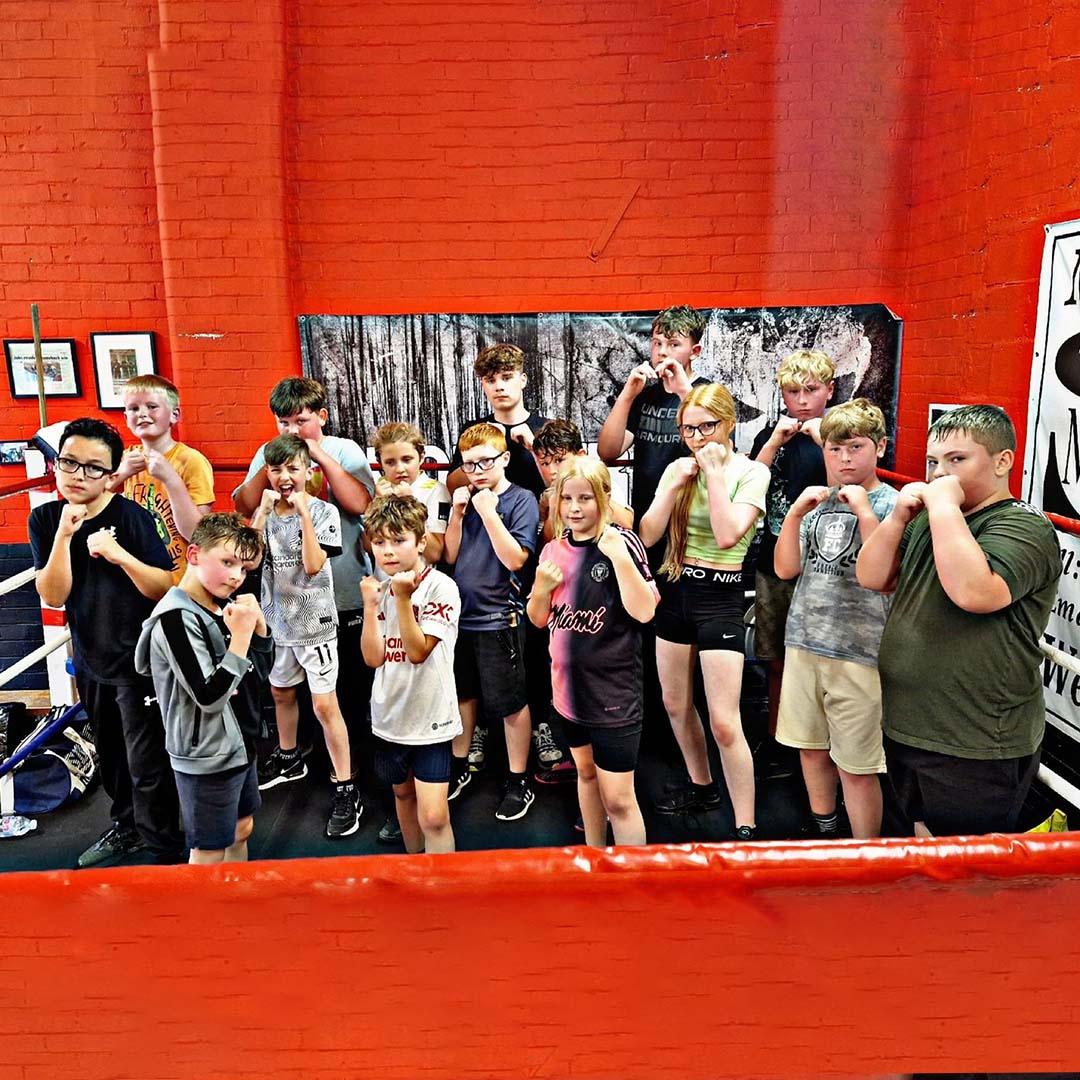 Group posing inside Lync gym facility