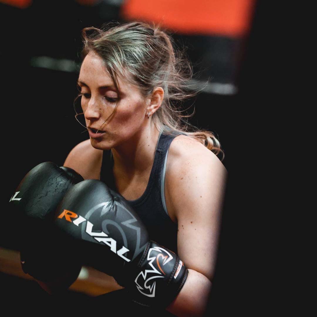 Female boxer wearing gloves during training