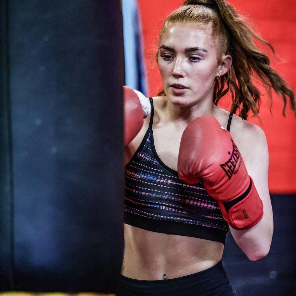 Female boxer training on punching bag at Lync Active gym