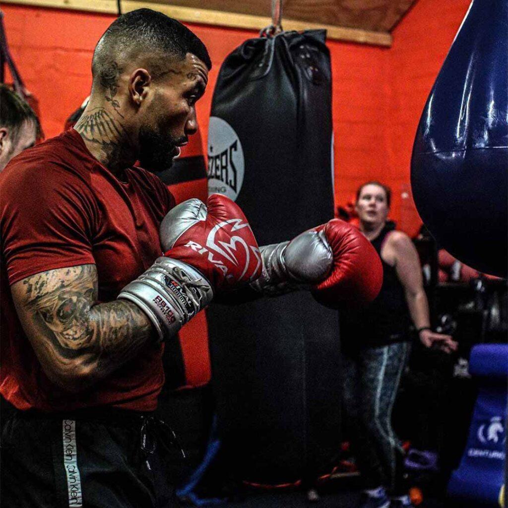 Boxing coach training athlete with focus mitts at Lync Active